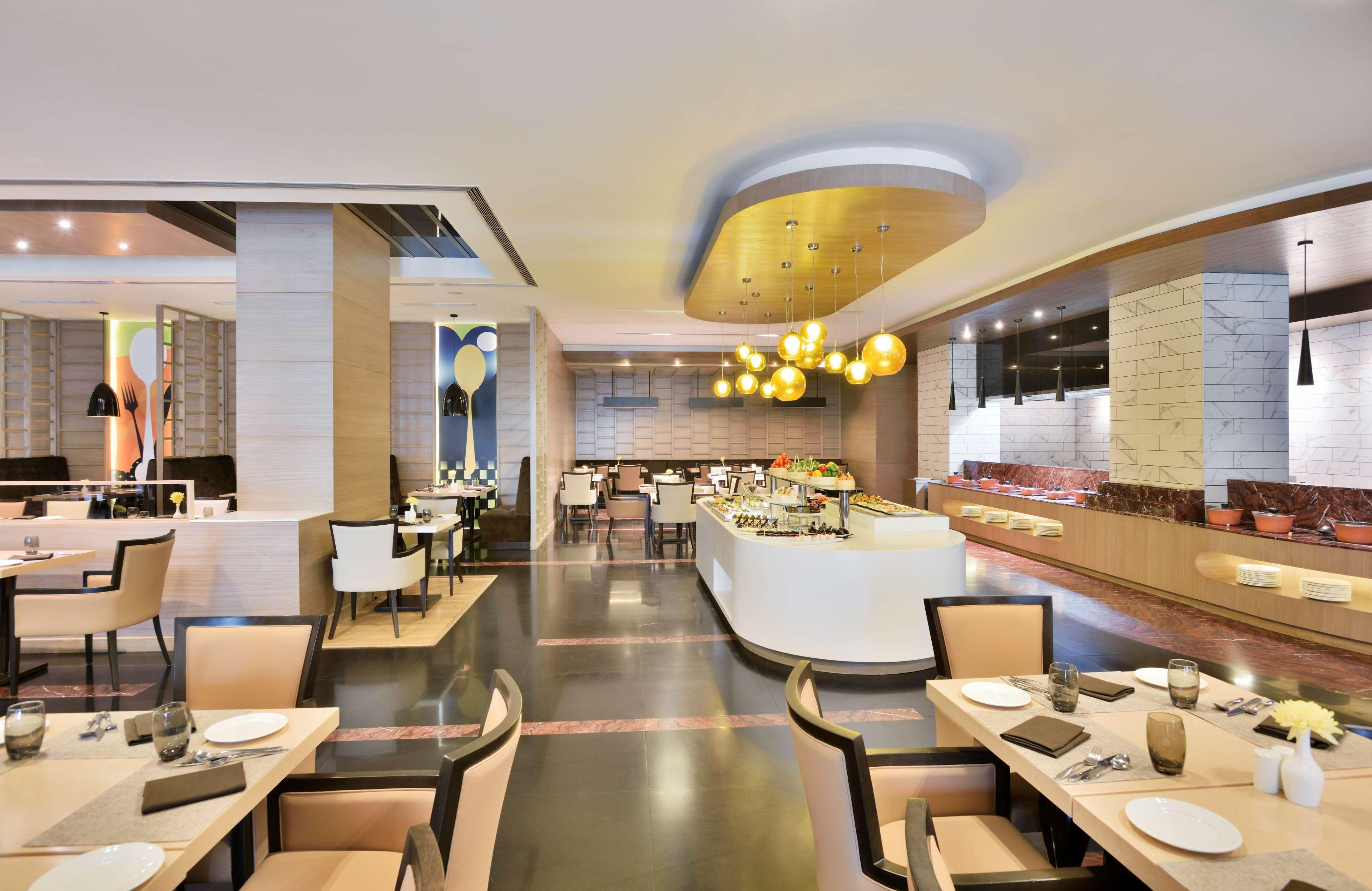 Radisson Gurugram Udyog Vihar Hotel Gurgaon Bagian luar foto The interior of the restaurant